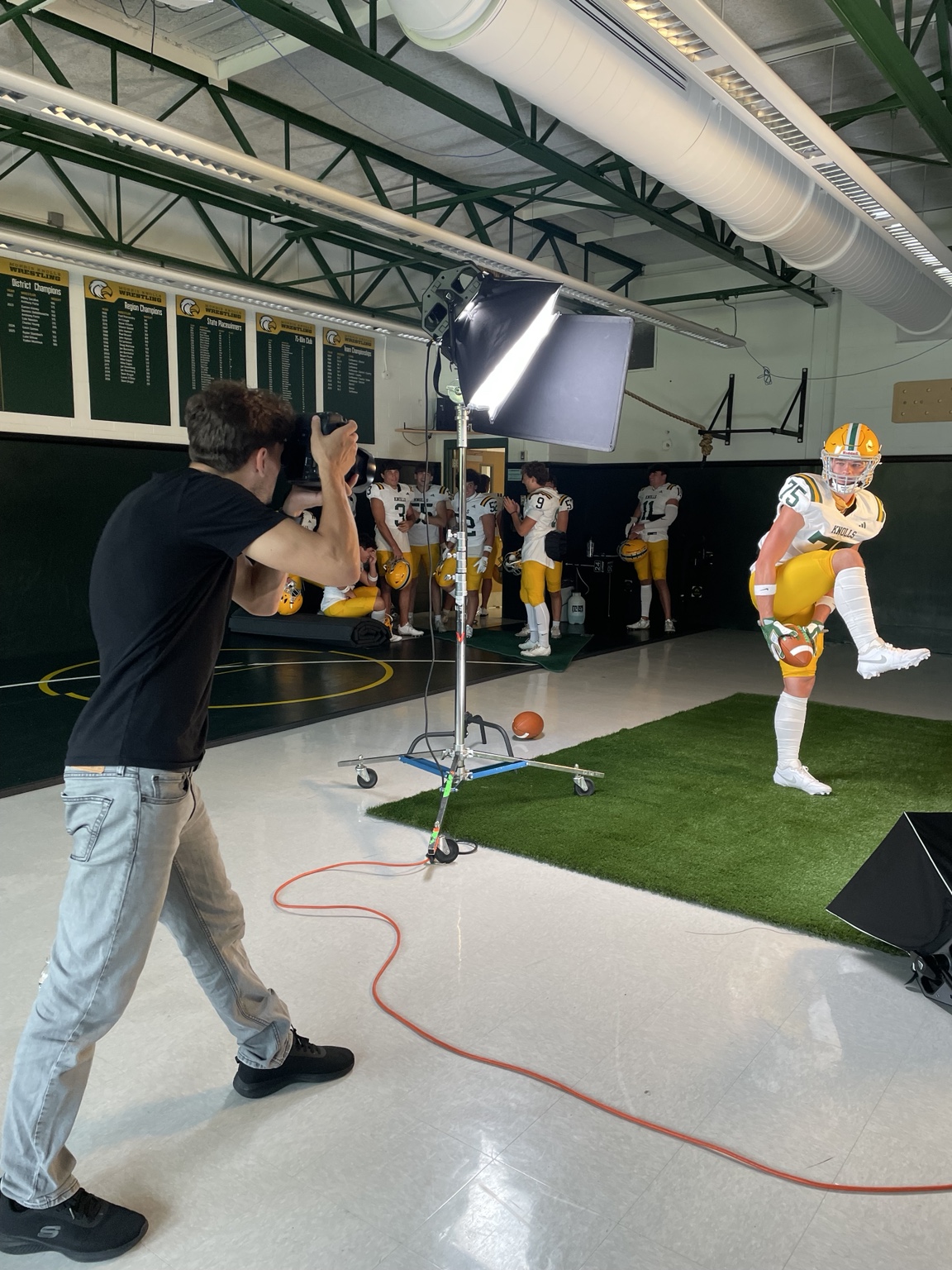 Utah photographing a football player with a studio lighting setup